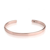 Rose gold bangle on a white background