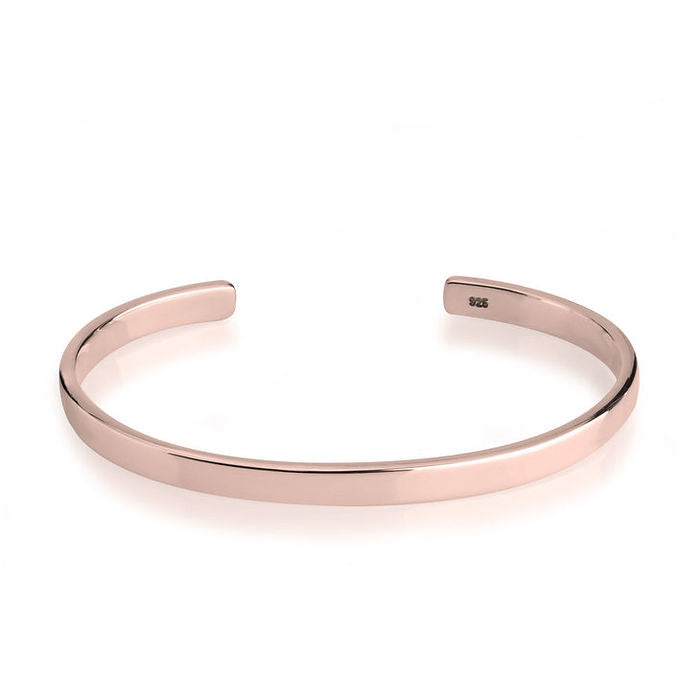 Rose gold bangle on a white background