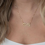 Gold infinity necklace with two interlocked letters