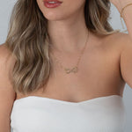 Infinity name necklace with heart worn on neck for size reference